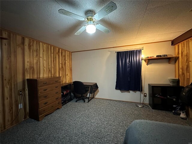 bedroom featuring ceiling fan, carpet, and wooden walls