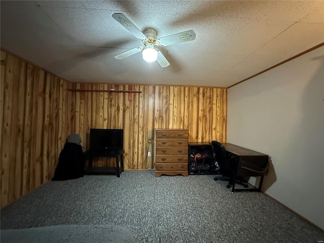 home office featuring wood walls and carpet