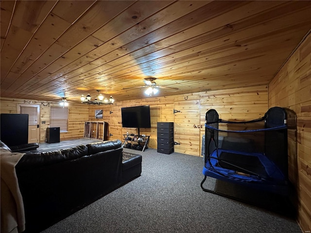 carpeted living room with wooden ceiling, ceiling fan, and wood walls