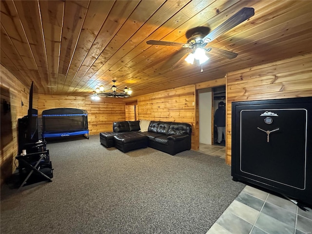 living area with wood walls, wooden ceiling, and a ceiling fan