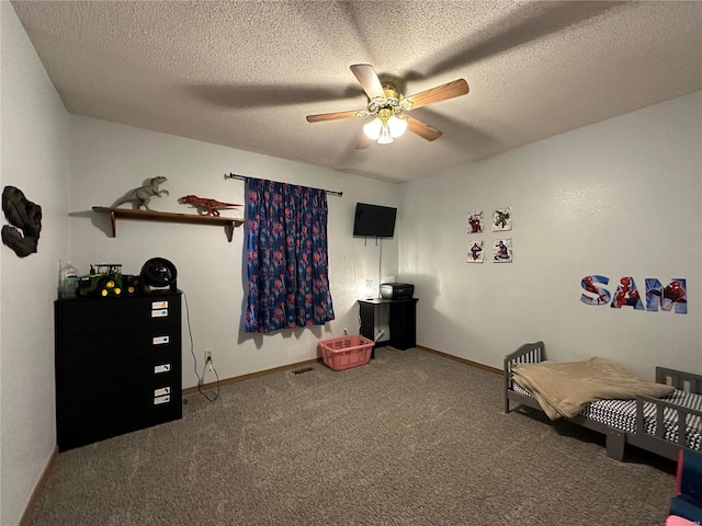 bedroom featuring a textured ceiling, carpet, and baseboards