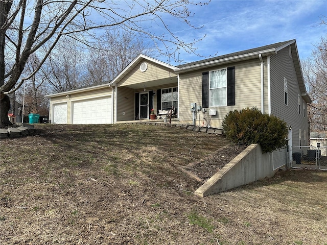 ranch-style home with fence and an attached garage