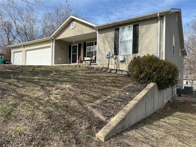 ranch-style home with a garage and fence