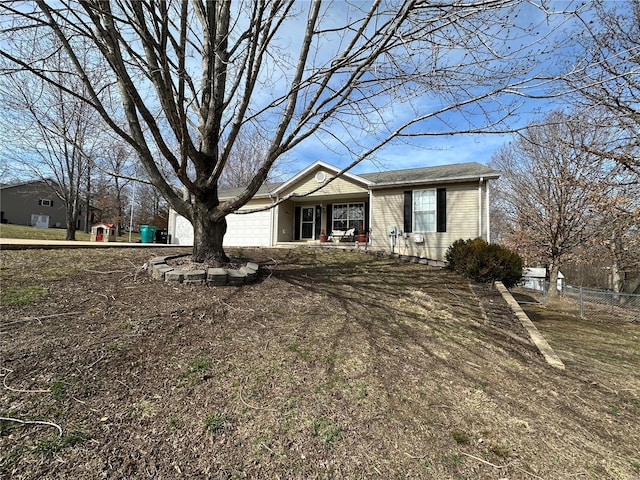 single story home with a garage and fence