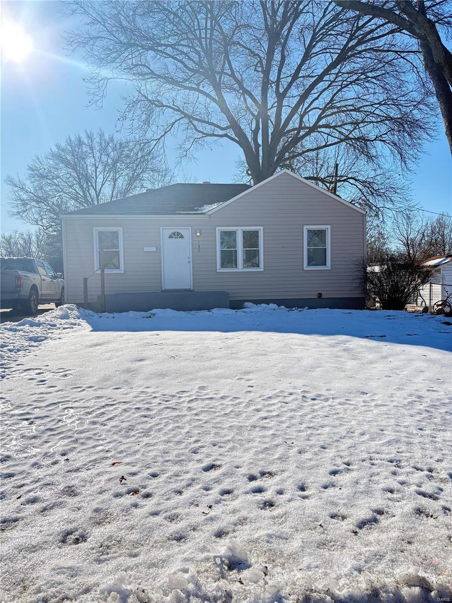 view of snow covered back of property