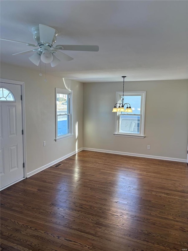 entrance foyer with ceiling fan with notable chandelier and dark hardwood / wood-style flooring