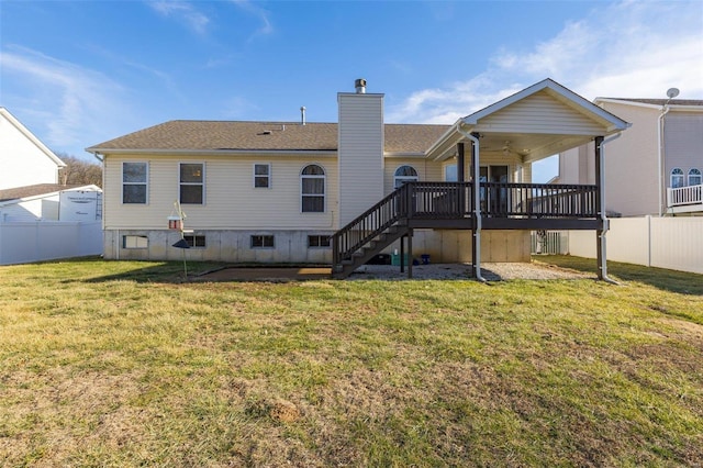 back of house featuring a wooden deck and a yard