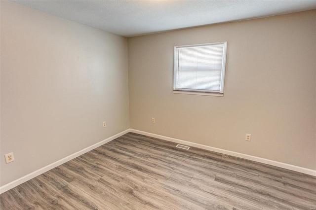 spare room featuring hardwood / wood-style flooring