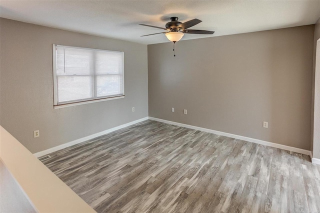 spare room with light hardwood / wood-style floors and ceiling fan