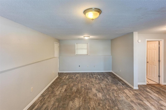 basement with dark hardwood / wood-style floors and a textured ceiling