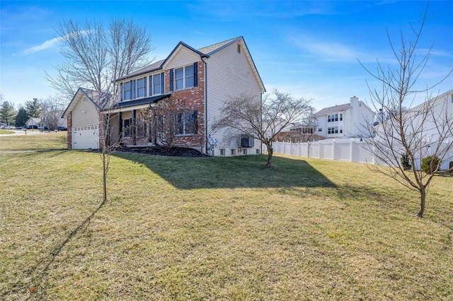 exterior space featuring an attached garage, fence, a front lawn, and brick siding