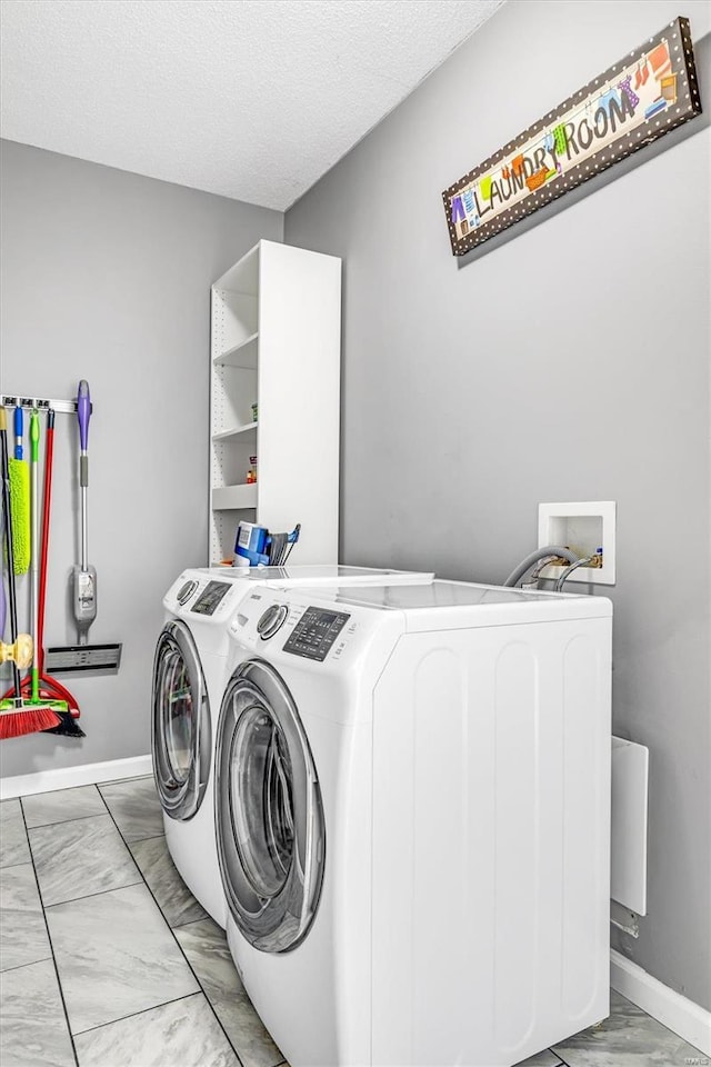 laundry area featuring laundry area, baseboards, marble finish floor, and washer and dryer