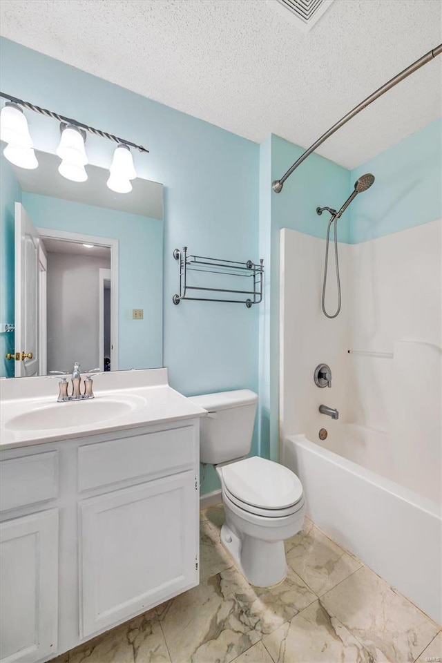 full bathroom with marble finish floor, bathtub / shower combination, toilet, a textured ceiling, and vanity