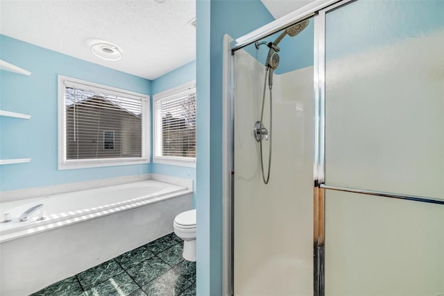 full bathroom featuring a stall shower, a garden tub, a textured ceiling, and toilet