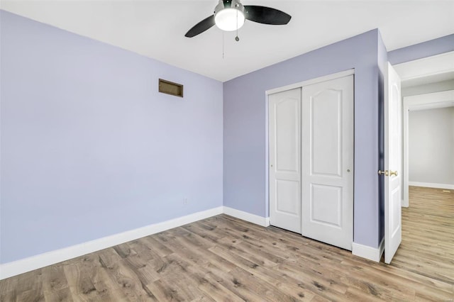 unfurnished bedroom featuring baseboards and wood finished floors