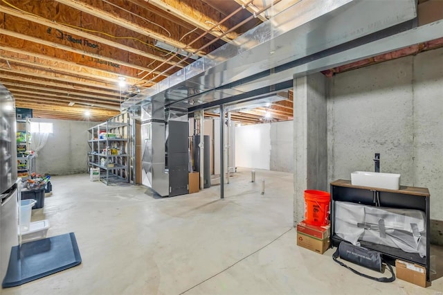 basement featuring water heater and heating unit