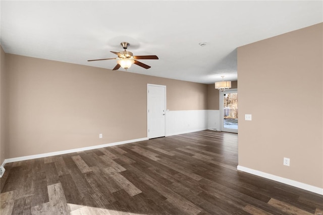 unfurnished room with dark hardwood / wood-style flooring and ceiling fan