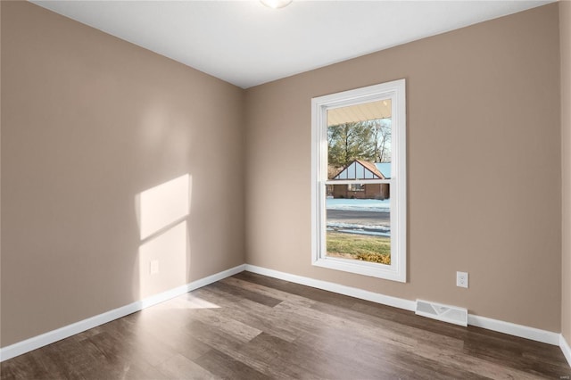 spare room featuring dark hardwood / wood-style flooring