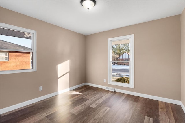 spare room featuring dark hardwood / wood-style flooring