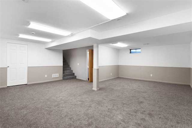 basement with brick wall and carpet