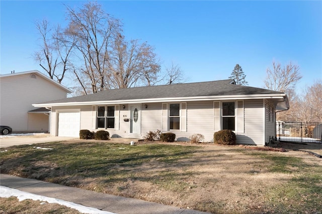 ranch-style house with a garage and a front lawn