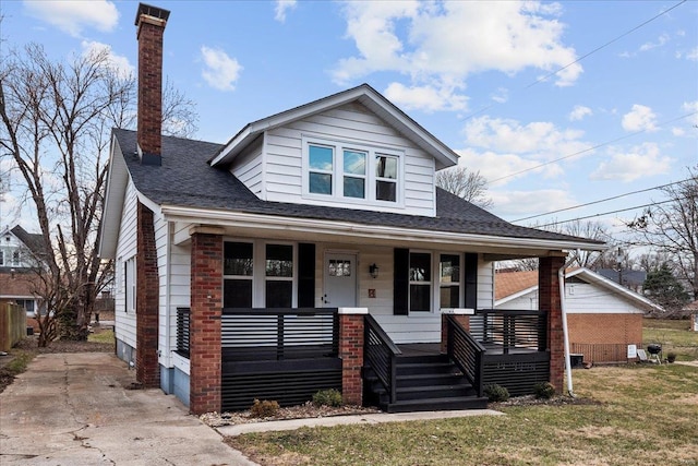 bungalow-style house featuring covered porch and roof with shingles