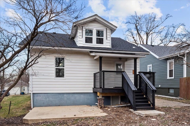 bungalow with stairs and a patio area