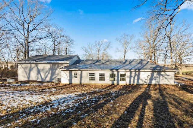 view of snow covered rear of property