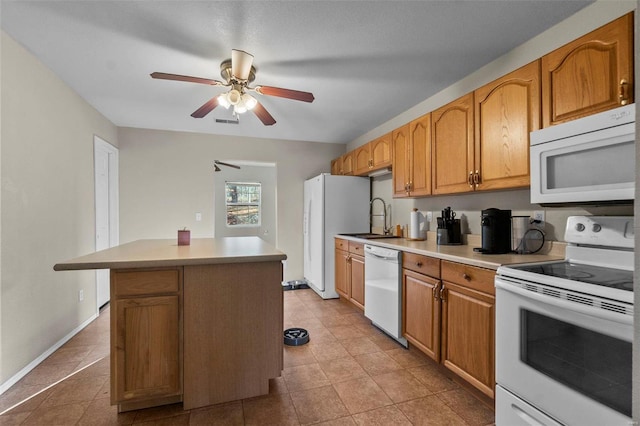 kitchen featuring sink, white appliances, light tile patterned floors, ceiling fan, and a kitchen island