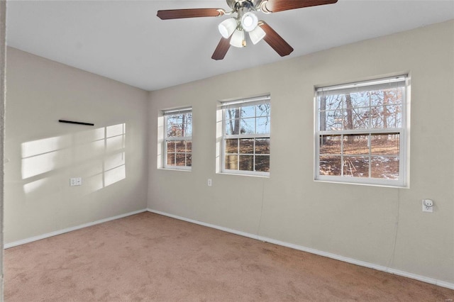 empty room featuring light colored carpet and ceiling fan