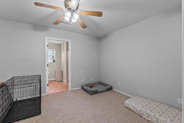 misc room with carpet floors and ceiling fan