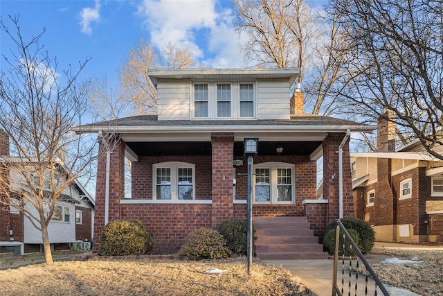 view of front of home with a porch and central AC