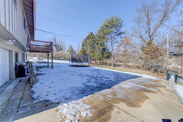 snow covered pool featuring a trampoline and grilling area