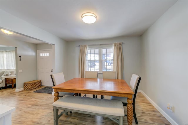 dining space with light hardwood / wood-style floors