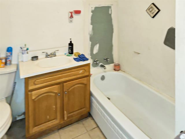 bathroom featuring vanity, a bathtub, tile patterned floors, and toilet