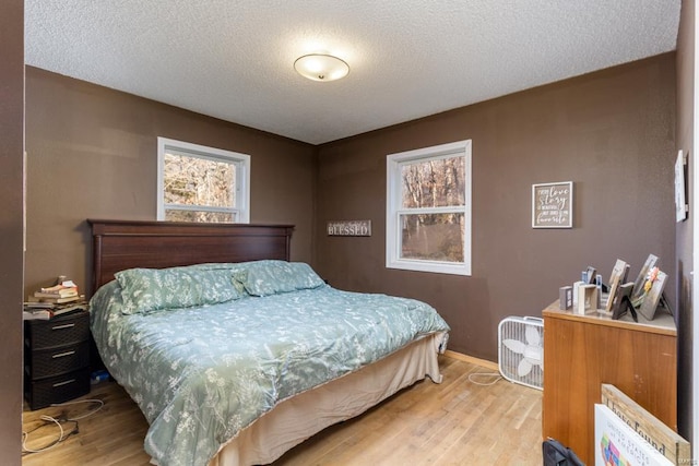 bedroom featuring a textured ceiling and wood finished floors