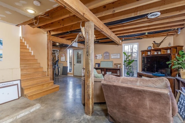 living room with visible vents, concrete floors, and stairway