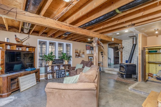 living area featuring concrete flooring and a wood stove