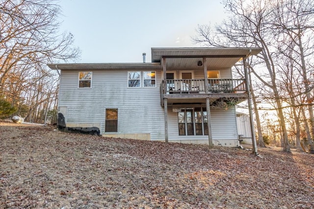 back of property with a balcony