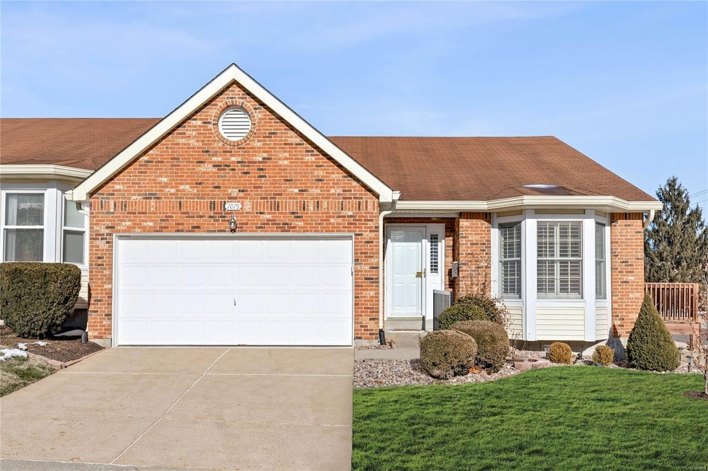 ranch-style home with a garage and a front yard