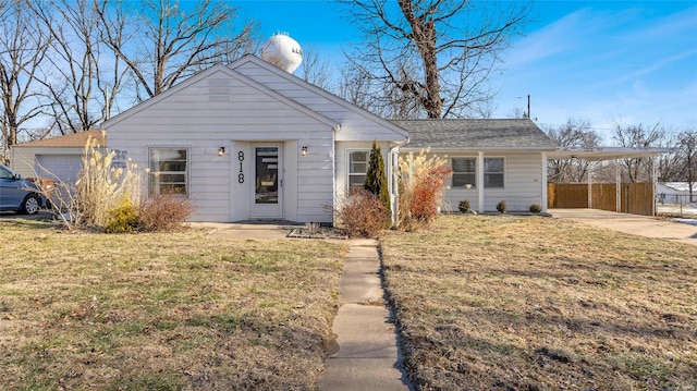 view of front of property with a front yard and a carport