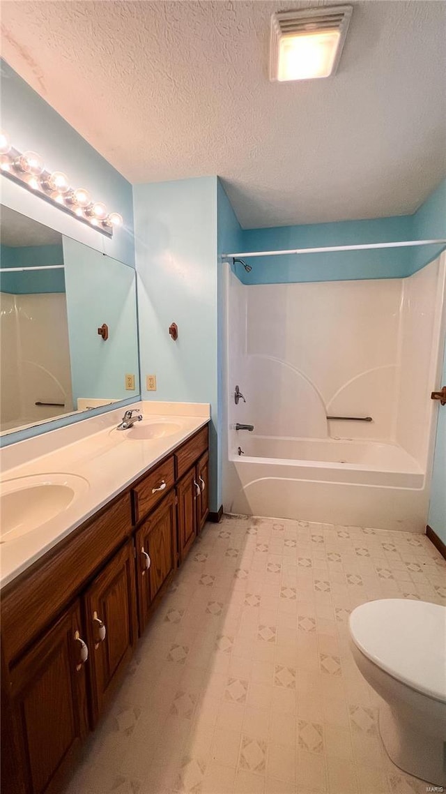 full bathroom with vanity, toilet, bathing tub / shower combination, and a textured ceiling