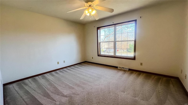 carpeted empty room featuring ceiling fan