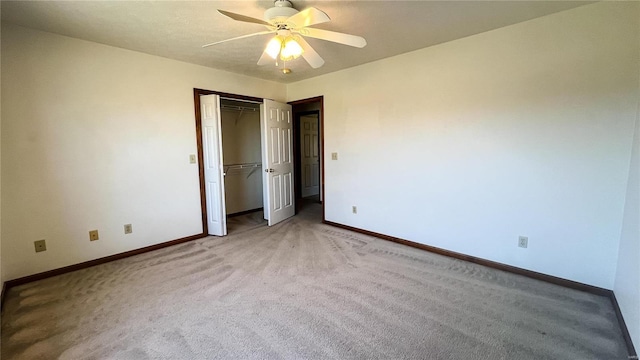 unfurnished bedroom with ceiling fan, carpet flooring, and a closet