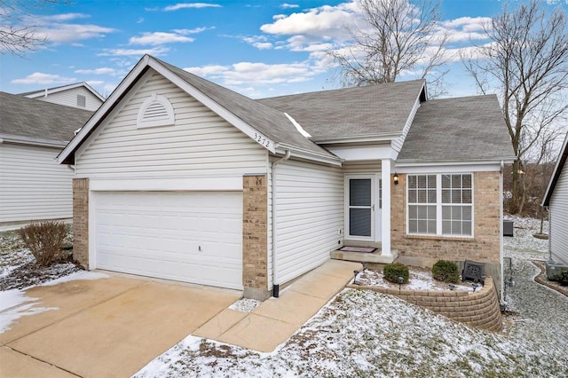 ranch-style house featuring a garage, concrete driveway, brick siding, and roof with shingles