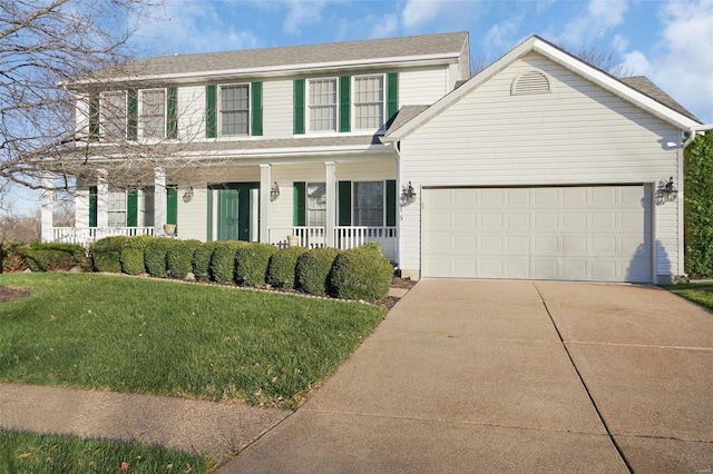 colonial house with a garage, a front yard, and covered porch