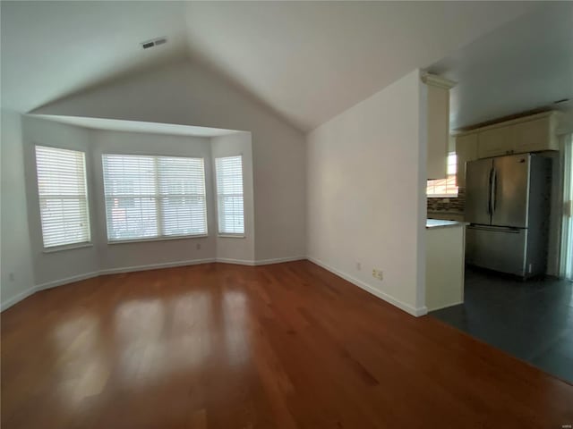 unfurnished living room with lofted ceiling and wood-type flooring