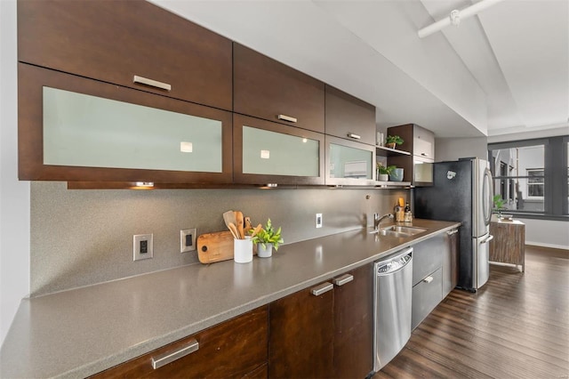 kitchen featuring dark brown cabinetry, appliances with stainless steel finishes, sink, and dark hardwood / wood-style floors