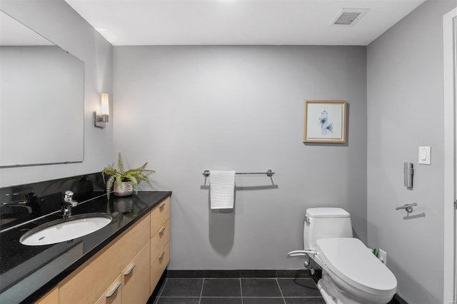 bathroom featuring tile patterned flooring, vanity, and toilet