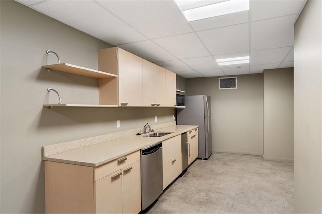 kitchen featuring stainless steel appliances, light carpet, sink, and a paneled ceiling